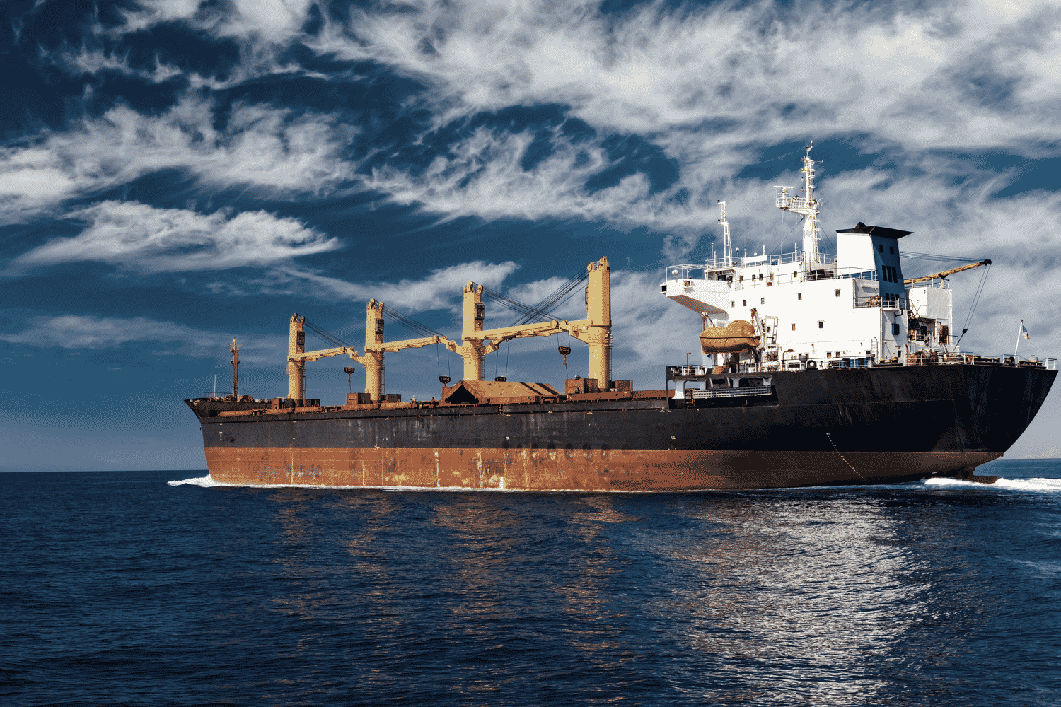cargo-ship-at-sea-against-the-blue-sky-logistics-a-6SU6NNJ